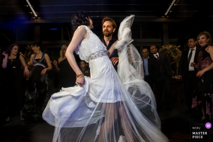 Wedding photographer for Ankara, Turkey - Pia Sera | couple on the dance floor surrounded by guests at the reception 