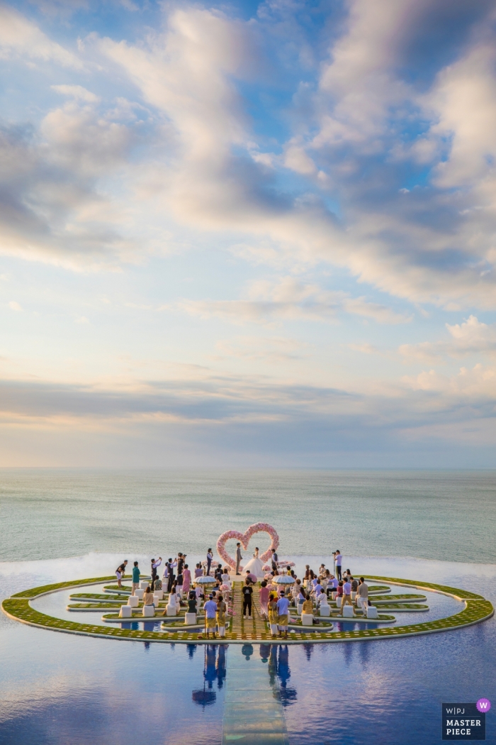 Photo by: <a href="https://www.wpja.com/contests/2019-v04-photography-competition/best-wedding-photographers/2462686">Leon Wong - Hangzhou </a> Photo of the ceremony on Fantasy Island in Bali with blue skies and clear water framing the wedding by a Zhejiang wedding photographer.