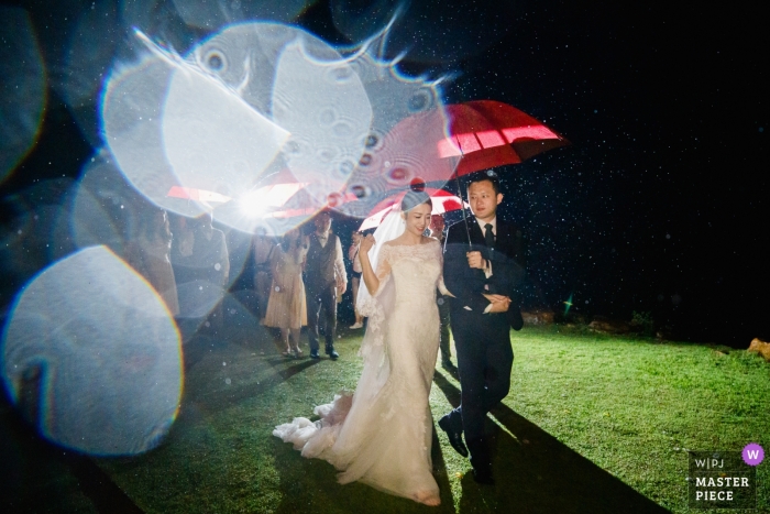 After the wedding ceremony in the rainstorm, people are leaving the location at The Ritz-Carlton, Krabi, Thailand