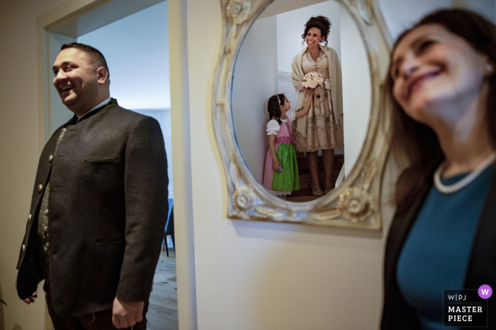 Photo by: <a href="https://www.wpja.com/contests/2019-v04/best-wedding-photographers/2463951">Pasquale Minniti - Reggio Calabria</a> Guests get their first look at the bride, reflected in the mirror, before her Austrian wedding in this photo by a Calabria wedding photographer.