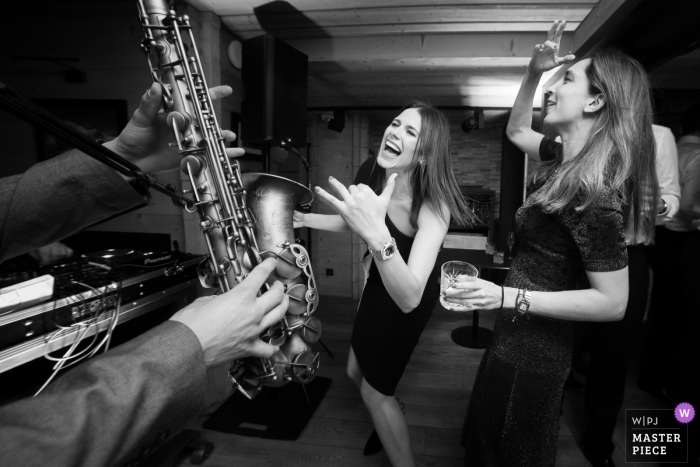 Photo by: <a href="https://www.wpja.com/contests/2019-v04/best-wedding-photographers/2464591">Sylvain Bouzat - Lyon </a> Megève Wedding Reception Photo of the Crazy party with Sax and Dancing Guests.