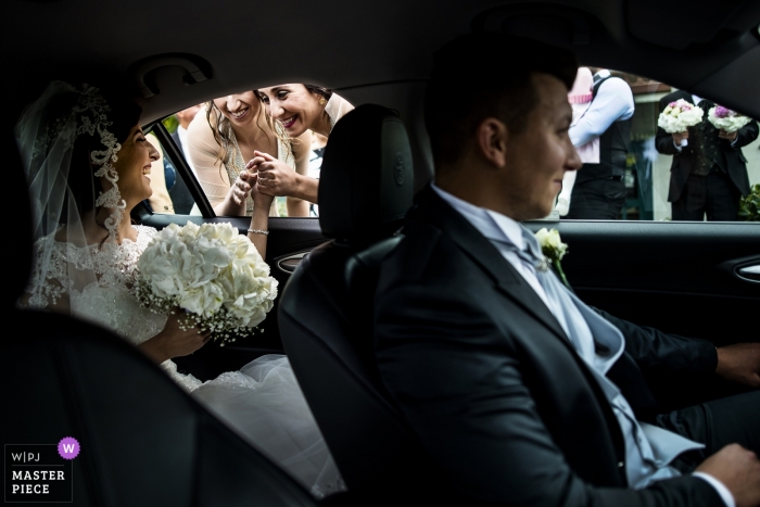 Riace in Reggio Calabria photo of the bride greeting her friends before the church ceremony