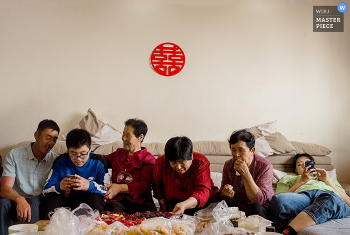 Photo by: <a href="https://www.wpja.com/contests/2019-v04/best-wedding-photographers/2465686">Moana Wu - Shanghai </a> Guests sit and wait for the ceremony to begin in Shandong in this photo by a China wedding photographer.