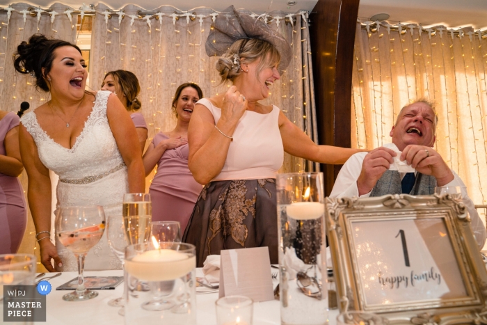 Fotografia de casamento Colshaw Hall - pai da noiva foi o alvo da piada do noivo com sua esposa e filha rindo ao longo