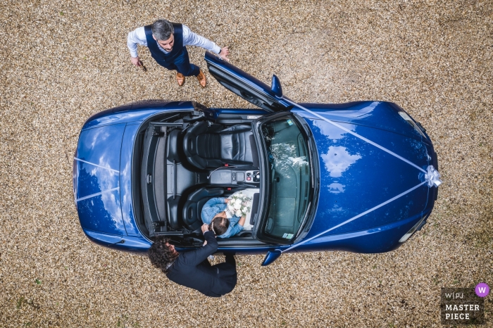Photo by: <a href="https://www.wpja.com/contests/2019-v04/best-wedding-photographers/2466296">Simon Cassanas - Paris </a> moulin des noues wedding day photography | moment capture with drone of bride in convertible car with groom