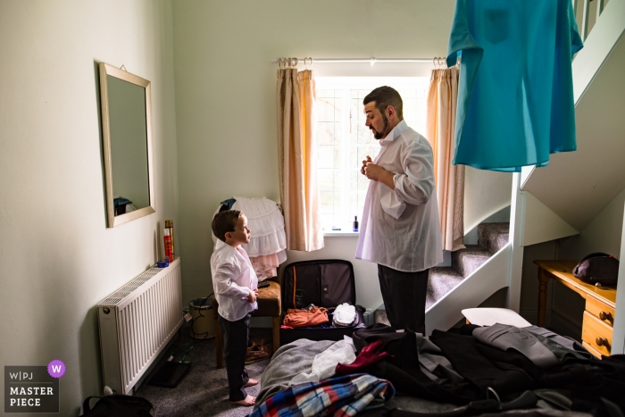 The groom and a young boy get ready for the ceremony at Clearwater Castle in Gloucestershire, England in this photo