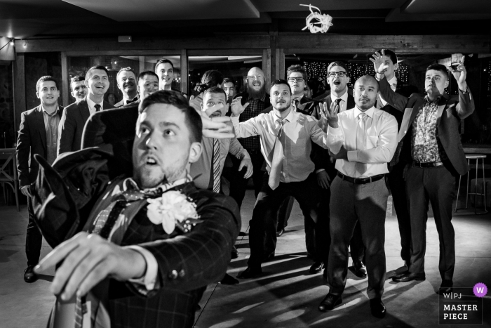 Photo by: <a href="https://www.wpja.com/contests/2019-v04/best-wedding-photographers/2466561">Sergio Cueto - Alcala de Henares Madrid</a> El Convento de Blanes photography of the groom throwing the garter to the men