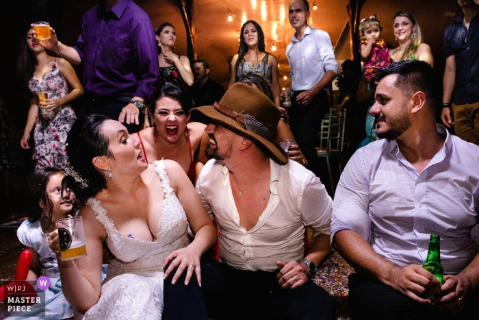 Photo by: <a href="https://www.wpja.com/contests/2019-v04/best-wedding-photographers/2466711">Vinicius Terror - Ouro Preto Minas Gerais</a> Photo of the bride and groom drinking with their friends during the reception in Pousada Avalon by a Brazil wedding photographer.