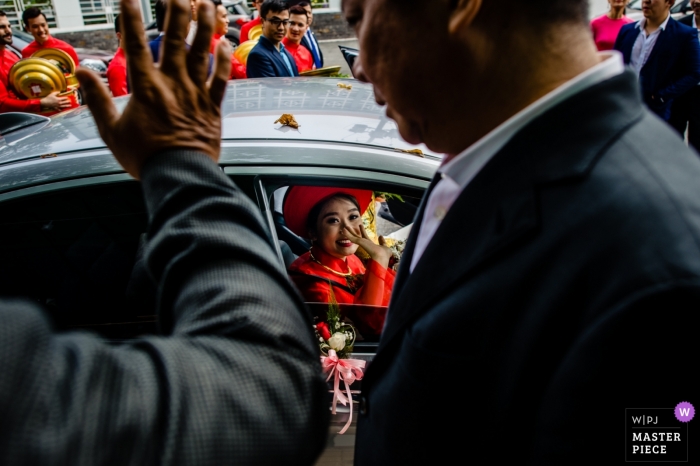 Photo by: <a href="https://www.wpja.com/contests/2019-v04/best-wedding-photographers/2467541">Huy Nguyen - Ho Chi Minh </a> Ho Chi Minh family members wave goodbye to the bride as she leaves in a car.