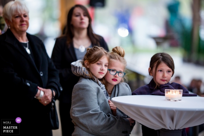 Photo by: <a href="https://www.wpja.com/contests/2019-v04/best-wedding-photographers/2468891">Victoria Sprung - Chicago Illinois</a> Wedding photo of little girls watching the ceremony at Bridgeport Art Center in Chicago