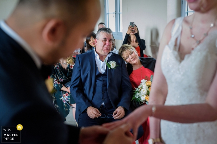 Foto por: <a href="https://www.wpja.com/contests/2019-v04/best-wedding-photographers/2469246"> Julien Roman - París </a> Fotografía de la ceremonia de la boda de Auxerre El padre llorando cuando la novia le puso el anillo a su hija