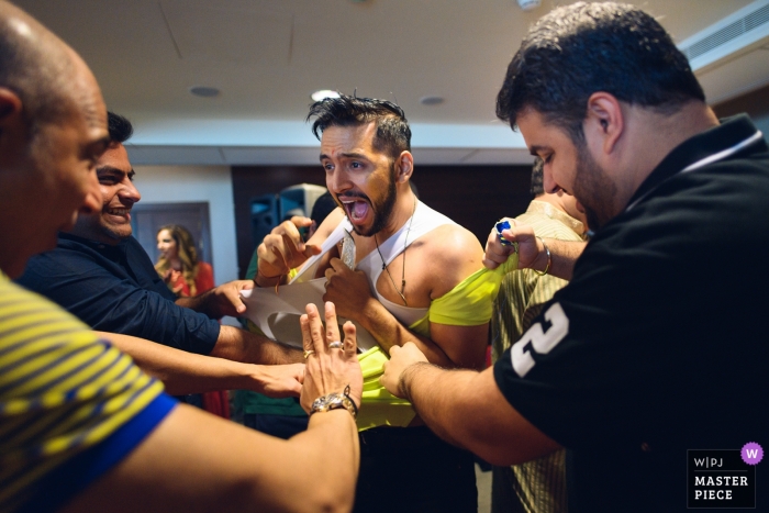 Photo by: <a href="https://www.wpja.com/contests/2019-v04/best-wedding-photographers/2469456">Ankita Asthana - Mumbai Maharashtra</a> Fairmont, Ajman Wedding Photographer said: All the friends and family get together and playfully tear the groom's clothes in a traditional ceremony. It can get all levels of crazy! It's called the haldi function where they start by applying turmeric