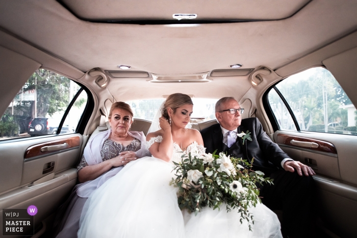 Photo by: <a href="https://www.wpja.com/contests/2019-v04/best-wedding-photographers/2472006">David Zaoui - Miami Florida</a> The Epic Hotel Miami FL wedding photo of the solemn atmosphere before the ceremony in the limo with bride and parents.