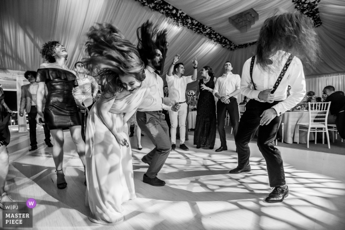 Photo by: <a href="https://www.wpja.com/contests/2019-v05/best-wedding-photographers/2473211">Mihai Zaharia - Bucharest București</a> Caracal, Romania - Dolce Vita Wedding Photography of Energetic guests at the reception, banging their heads on rock music
