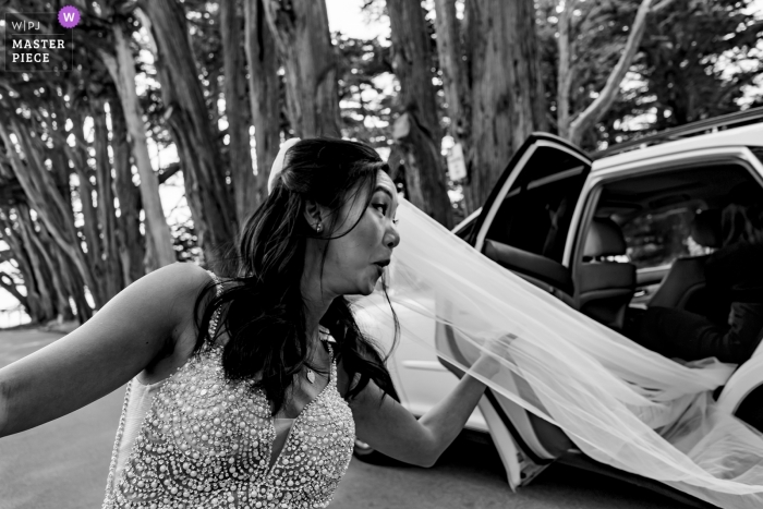 Photo by: <a href="https://www.wpja.com/contests/2019-v05/best-wedding-photographers/2473776">Raymond Nguyen - Sacramento California</a> Half Moon Bay - Harley Farms Wedding Photograph of the brides stuck veil in the car.