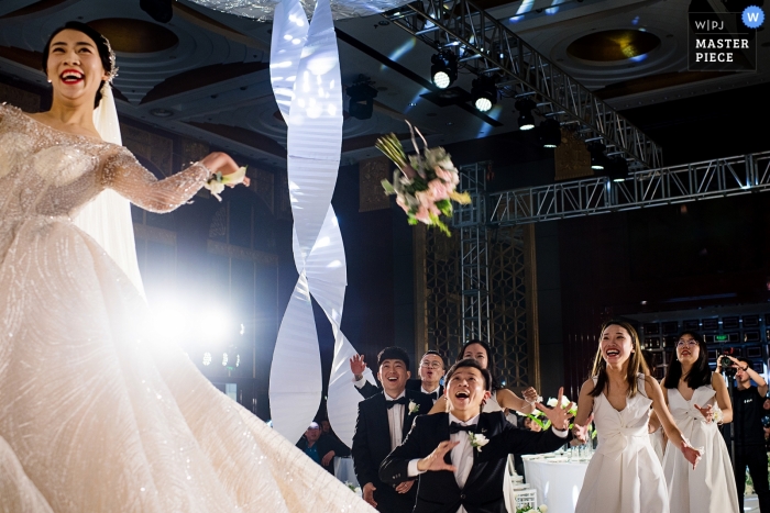 Photo by: <a href="https://www.wpja.com/contests/2019-v05/best-wedding-photographers/2474646">Moana Wu - Shanghai </a> Throwing wedding bouquet at the China Shandong reception.
