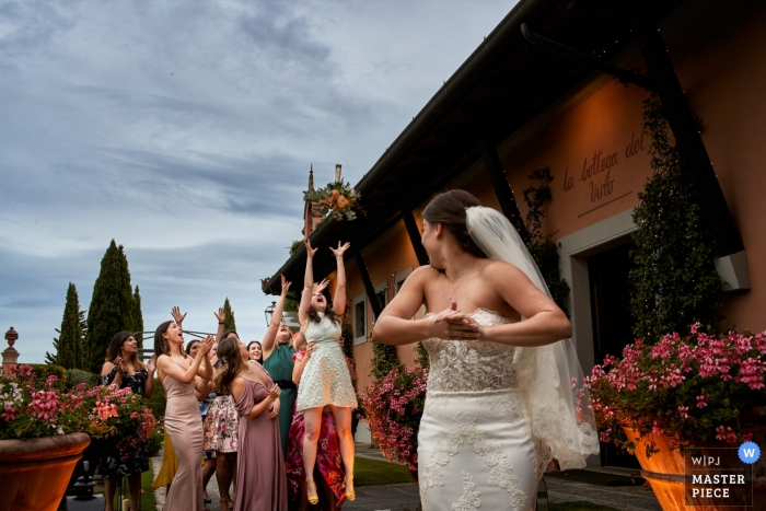 Photo by: <a href="https://www.wpja.com/contests/2019-v05/best-wedding-photographers/2476251">Damiano Salvadori - Certaldo Firenze</a> Antica Fattoria di Paterno - Tuscany classic wedding photo of "throwing the bouquet"