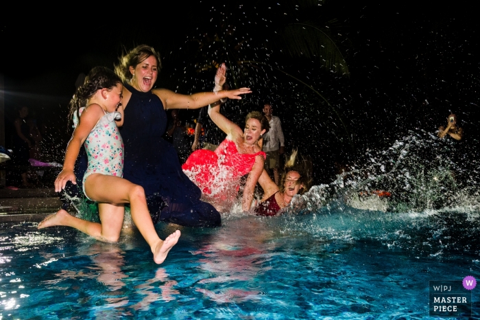 Photo by: <a href="https://www.wpja.com/contests/2019-v05/best-wedding-photographers/2477526">Khoi Le - Ho Chi Minh City </a> Ho Chi Minh wedding photographer captured this photo of the wedding guests jumping into the pool at the wedding reception.