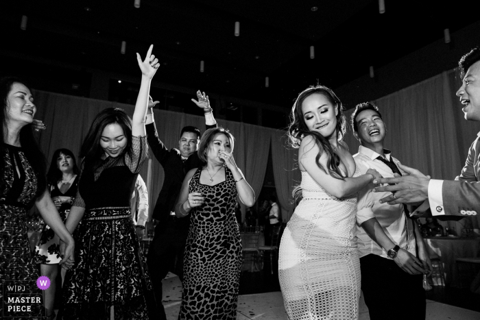 Photo by: <a href="https://www.wpja.com/contests/2019-v05/best-wedding-photographers/2480566">Chris Shum - Sunnyvale California</a> Palo Alto Community Center Reception Photo from the dance floor with action and expressions