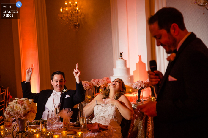 Photo by: <a href="https://www.wpja.com/contests/2019-v05/best-wedding-photographers/2480761">Miguel Gonzalez - Abington Pennsylvania</a> The Ballroom at Ellis Preserve Wedding Reception Photo - Best man makes a great joke at speeches.