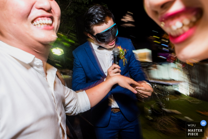 Photo by: <a href="https://www.wpja.com/contests/2019-v05/best-wedding-photographers/2480971">Huy Nguyen - Ho Chi Minh </a> Ho Chi Minh wedding photographer captured this photo of the groom wearing a blindfold while playing a game at the reception