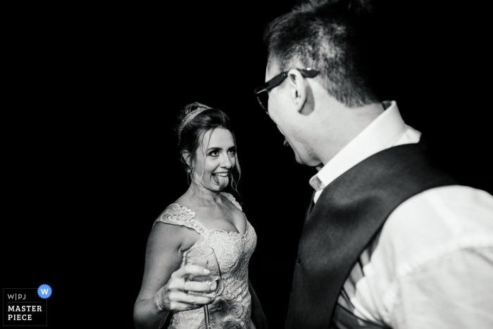 Allegro Buffet - São Caetano do Sul wedding photo showing the bride and groom having fun with their tongues showing each other 