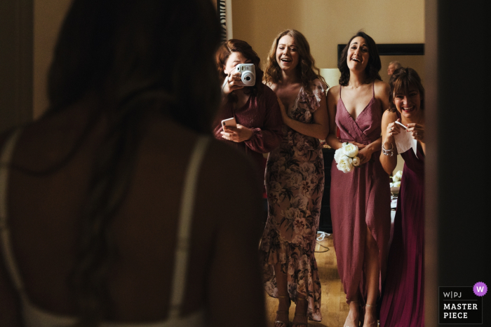 Hotel Grand Cavour, Florence, Italy Wedding Photographer - Image taken as bridesmaids see bride in her dress for the first time 