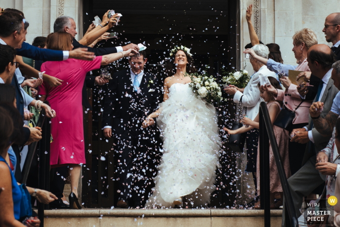 Photo by: <a href="https://www.wpja.com/contests/2019-v05/best-wedding-photographers/2482176">Lyndsey Goddard - London London</a> Islington Town Hall wedding photograph showing the bride and groom under confetti on the steps of town hall