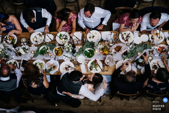 Abbey Hall Creative Space Photographer | The Bride + Groom share a private moment at the Tope Table in this reception photo