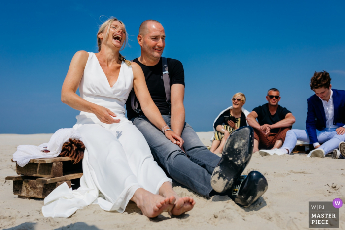 Photo by: <a href="https://www.wpja.com/contests/2019-v05/best-wedding-photographers/2483156">Leonard Walpot - Utrecht Utrecht</a> Wedding photograph of the bride and groom sitting at Terschelling during the ceremony