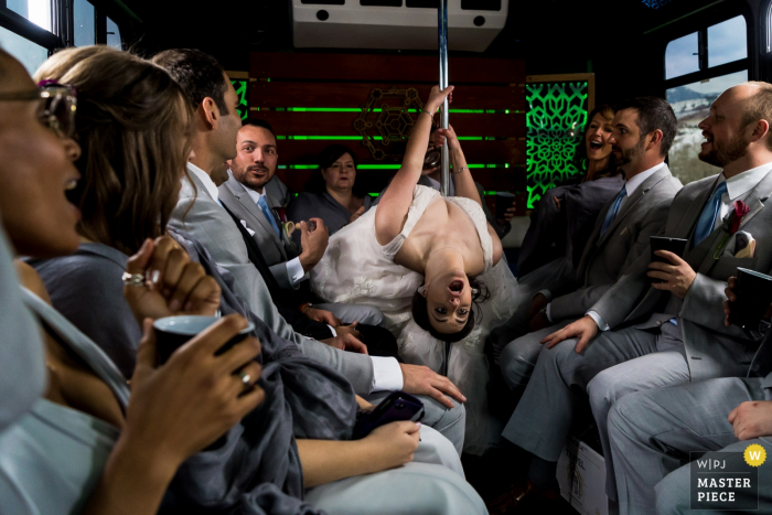 Photo by: <a href="https://www.wpja.com/contests/2019-v05-photography-competition/best-wedding-photographers/2483436">Brenda Bergreen - Evergreen Colorado</a> Pictures of the Bridal party riding from the ceremony to the reception at The Pines at Genesee on a party bus.