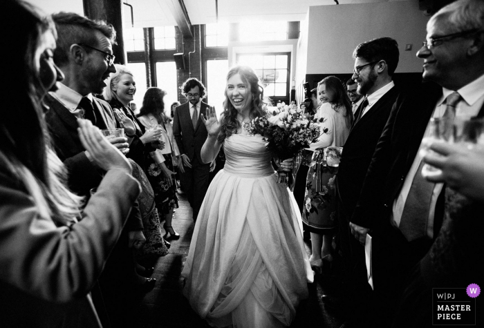 wedding venue photograph showing the bride arriving at reception Harrild and Sons, London wedding photograph showing the bride arriving at reception