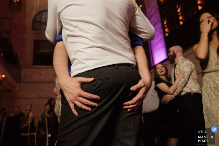 Photo by: <a href="https://www.wpja.com/contests/2019-v05/best-wedding-photographers/2484341">Meg Brock - Holland Pennsylvania</a> Philadelphia, PA The Union Trust wedding reception photo of a Guest Getting Grabby