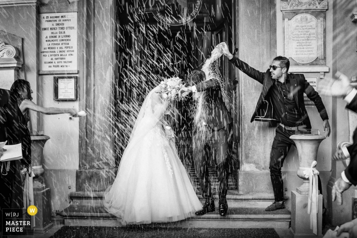 Photo by: <a href="https://www.wpja.com/contests/2019-v06/best-wedding-photographers/2487016">Alessandro Colle - Massa Massa-Carrara</a> santuario di montenero livorno | wedding photography of the confetti moment with bride and groom
