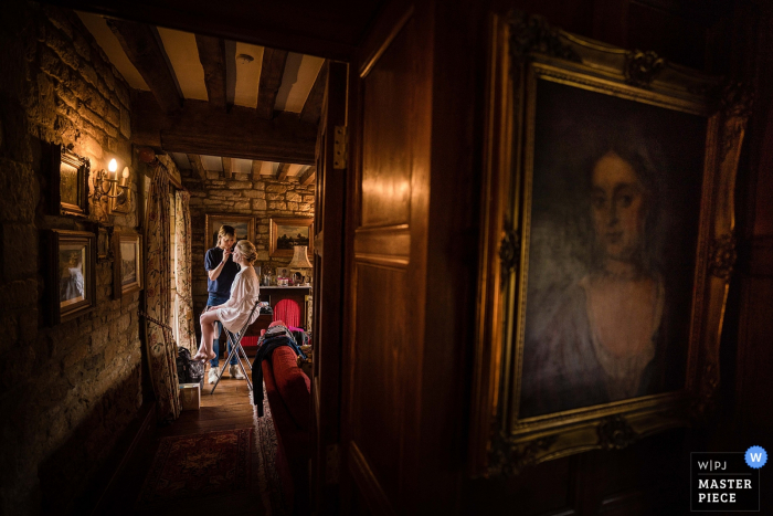Photo by: <a href="https://www.wpja.com/contests/2019-v06/best-wedding-photographers/2487866">Linus Moran - Weymouth Dorset</a> Photo of the bride sitting in the Make Up Artists chair as she is prepared for her Cotswolds wedding.