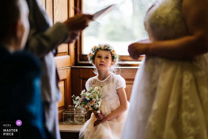 Photo by: <a href="https://www.wpja.com/contests/2019-v06/best-wedding-photographers/2489136">Kristian Leven - London</a> Hestercombe House Wedding Photographer - One of the flowergirls watches on as the Bride speaks to the registrar