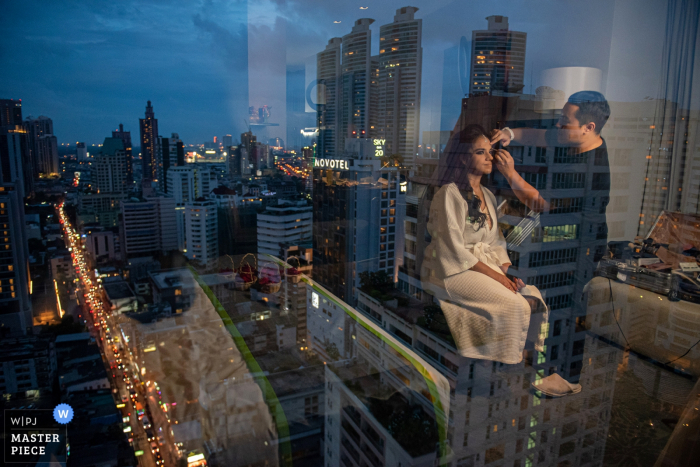 Photo by: <a href="https://www.wpja.com/contests/2019-v06/best-wedding-photographers/2490151">Vutiporn Supanish - Bangkok Bangkok</a> Holiday Inn Sukhumvit Wedding Photographer: "The mirror image is what I want to tell about the time and atmosphere of the makeup of the bride before the party starts celebrating."