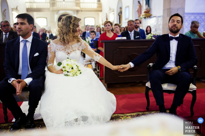 Photo by: <a href="https://www.wpja.com/contests/2019-v06/best-wedding-photographers/2490551">Paulo Castro - Guimaraes </a> Igreja de S. Miguel de Vila das Aves - Portugal | Ceremony Photography showing the godfather's emotion