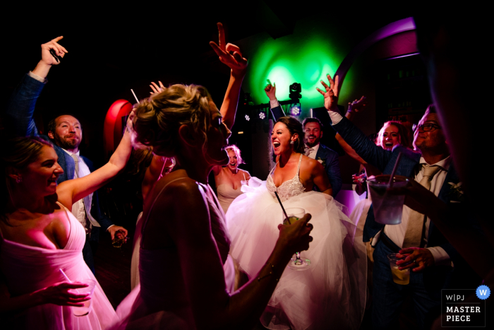 Photo by: <a href="https://www.wpja.com/contests/2019-v06/best-wedding-photographers/2491551">Michael Freas - Key West Florida</a> Casa Marina Resort Key West, Florida Weddings - CO2 cannon had just been fired. The DJ dropped it right at the same time. Bride was jumping non stop and then they started a circle dance. DJ fired the cannon again, just prior to me snapping this image.