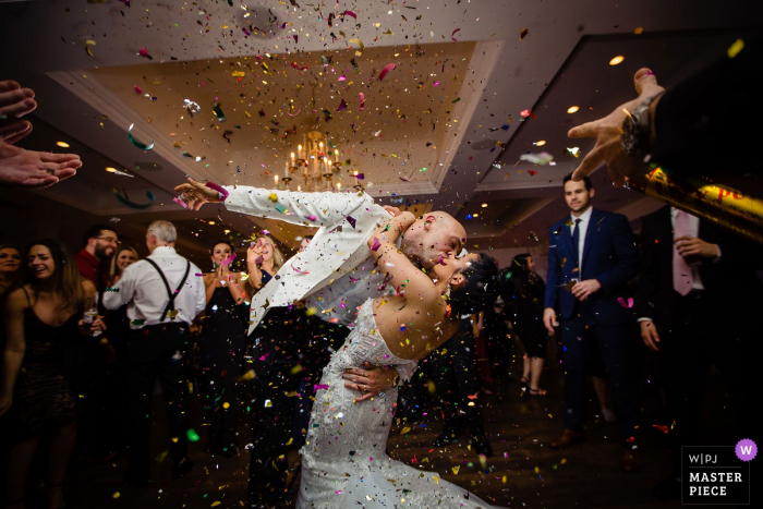 Photo by: <a href="https://www.wpja.com/contests/2019-v06/best-wedding-photographers/2491926">Miguel Gonzalez - Abington Pennsylvania</a> Icona Avalon Wedding Reception Photography - Bride and Groom Came out for introductions and a groomsman shot off confetti.