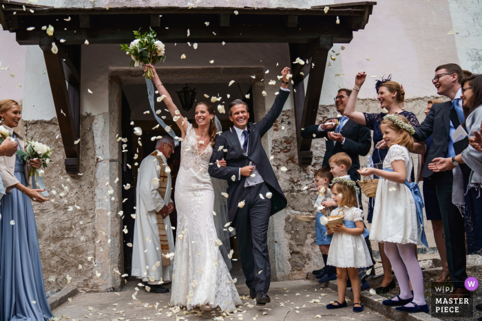 Photo by: <a href="https://www.wpja.com/contests/2019-v06/best-wedding-photographers/2492931">Boni Bonev - Sofia Sofia</a> Zell Am See, Schloss Prielau, Austria wedding photo showing confetti exit for the happy bride and groom