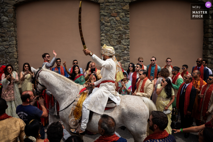 Photo by: <a href="https://www.wpja.com/contests/2019-v06/best-wedding-photographers/2492956">Donatella Barbera - Certaldo Firenze</a> Renaissance Tuscany Il Ciocco Destination Indian wedding photograph of groom arriving on horseback with sword raised