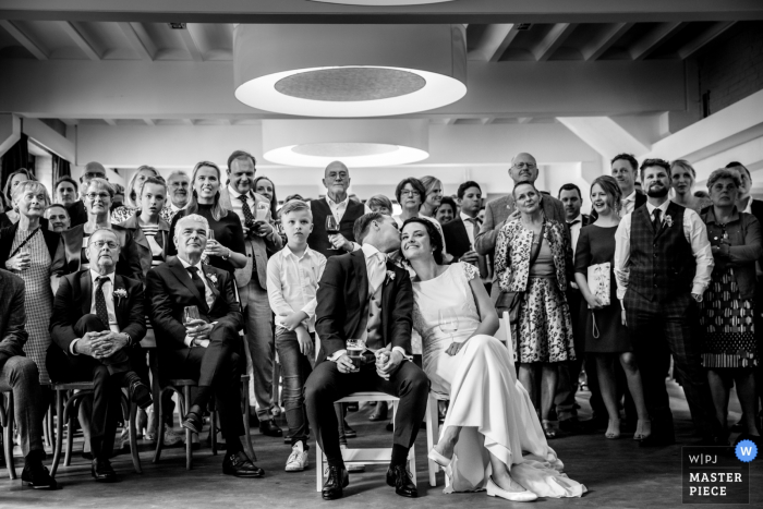 Photo by: <a href="https://www.wpja.com/contests/2019-v06/best-wedding-photographers/2493246">Indra Simons - Enschede Overijssel</a> Wedding Reception Photography at Hengelo - De Houtmaat - image of slideshow watching with friends and family