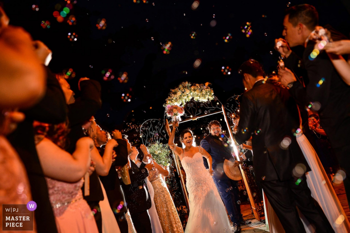 Paioça do cabloco couple leaving the ceremony at night in this wedding photograph.