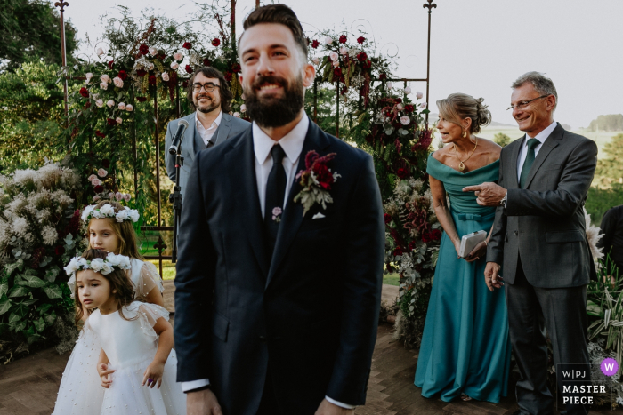Photo by: <a href="https://www.wpja.com/contests/2019-v06/best-wedding-photographers/2495426">Renan Radici - Porto Alegre Rio Grande do Sul</a> The groom waits for the bride at the altar at Vinicola Laurentia in this documentary-style wedding photo by a Rio Grande do Sul, Brazil photographer.