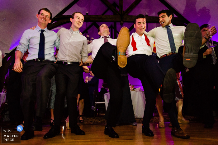 Photo by: <a href="https://www.wpja.com/contests/2019-v06/best-wedding-photographers/2495551">Kate Crabtree - Bangor Maine</a> Bar Harbor Club Wedding Reception Photography - The groom and his friends dance together at his Bar Harbor Maine wedding