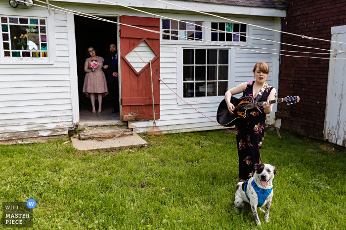 Photo by: <a href="https://www.wpja.com/contests/2019-v06/best-wedding-photographers/2495721">Sarah V. Martinez - Dover New Hampshire</a> Greene, Maine wedding photography - The bride awaits with her brother for the musical queue to enter the ceremony at the family farmhouse