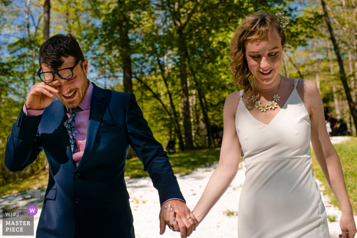 Photo by: <a href="https://www.wpja.com/contests/2019-v06-photography-competition/best-wedding-photographers/2495811">Ilana Bar-av - Madison Wisconsin</a> Deerfields Campground wedding photo of the Bride and Crying Groom Post-Ceremony - Madison, WI wedding photographer