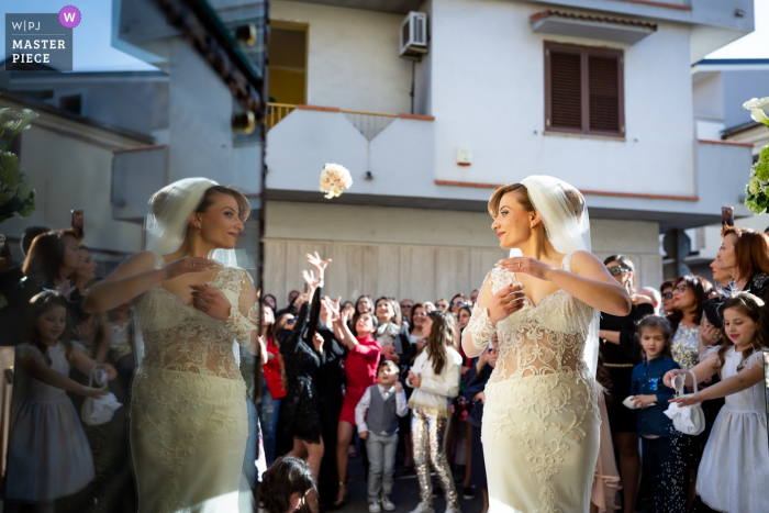Photo by: <a href="https://www.wpja.com/contests/2019-v07/best-wedding-photographers/2500861">Danilo Muratore - Rosarno Reggio Calabria</a> The bride turns toward her reflection as she tosses her bouquet over her shoulder in front of the Villa Blanche in this wedding photo composed by a documentary-style Calabria photographer.
