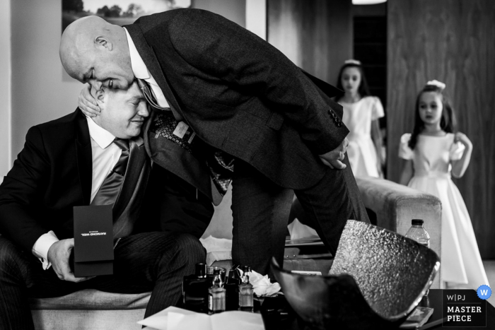 Photo by: <a href="https://www.wpja.com/contests/2019-v07/best-wedding-photographers/2502416">Andy Griffiths - St. Helens Lancashire</a> The Mere Wedding Photographer - Groom hugging his dad after opening a card from his bride